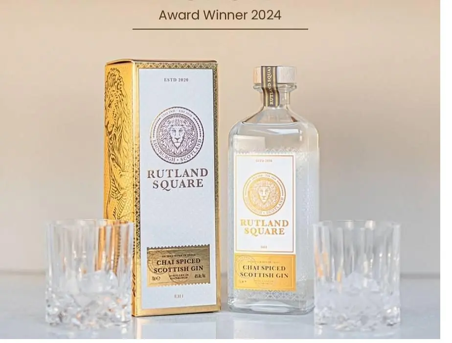 A gold gift box and a bottle of Rutland Square Chai Spiced Scottish Gin between two glasses, under the words Award Winner 2024