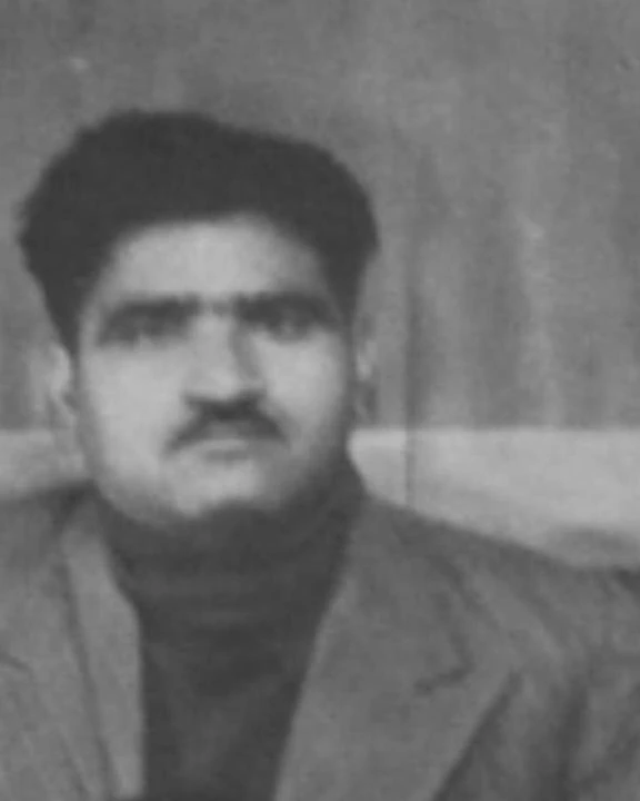 Tej Ram Bawa in an old black-and-white photograph, with thick dark hair and a moustache, in a jacket over a dark polo neck